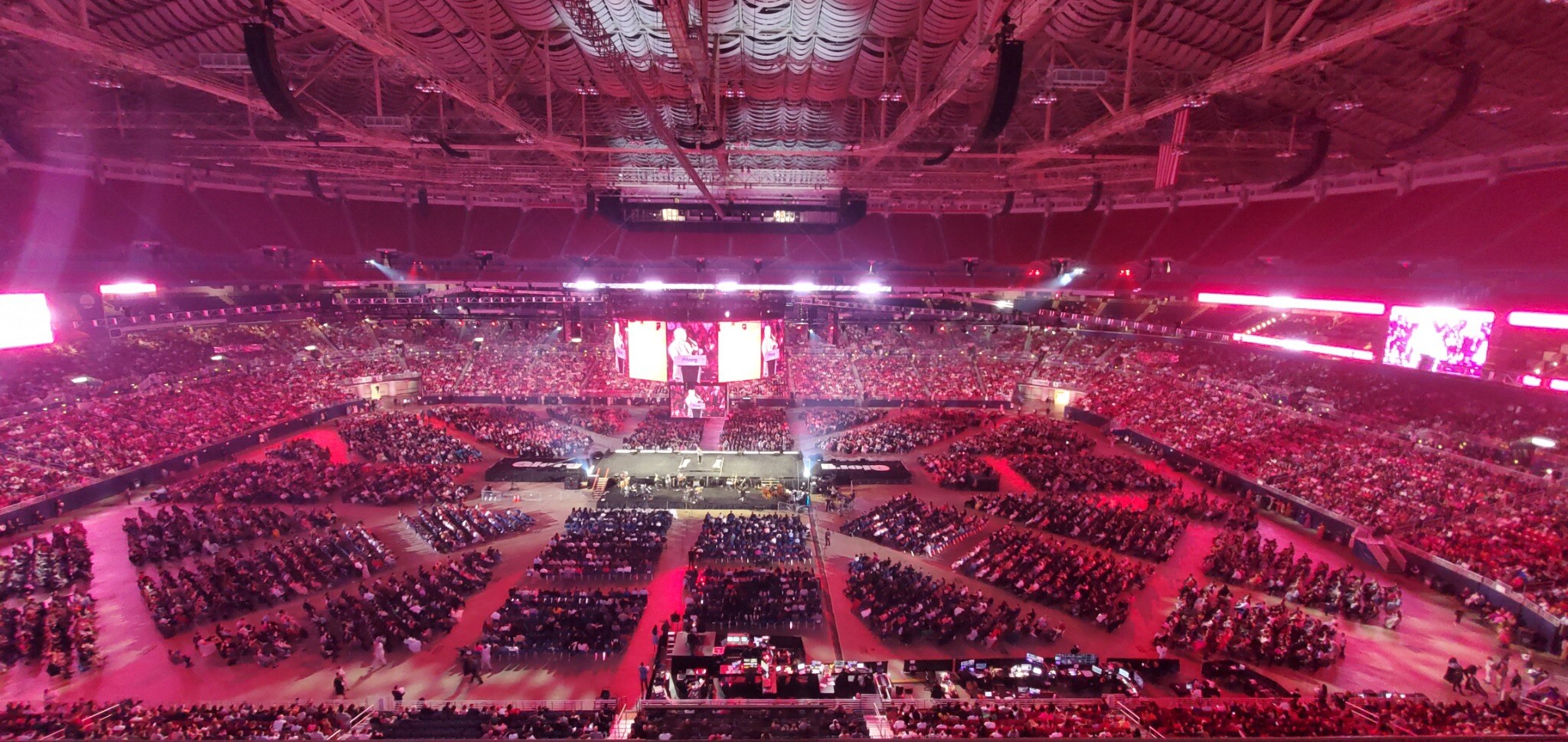 Full-arena view of the NAYC Youth Congress stage, suspended video, lighting, and audience